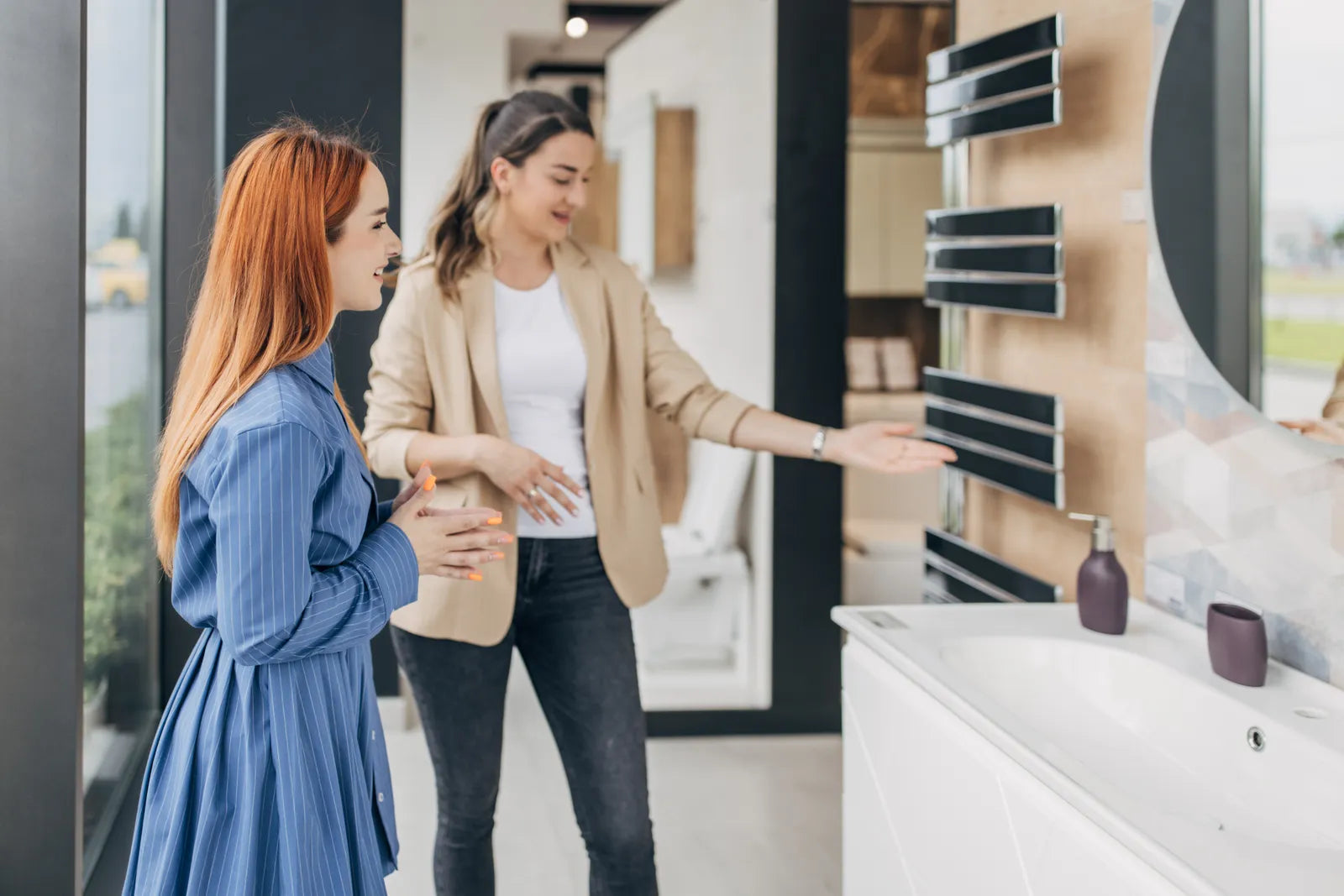Shopper comparing toilets in a bathroom fixture showroom