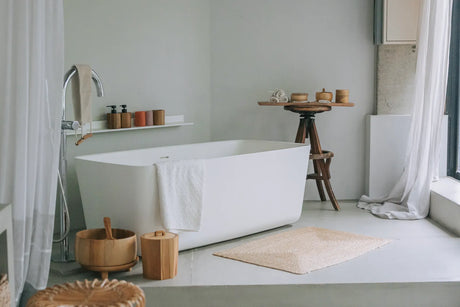 Modern freestanding soaker bathtub in a bright renovated bathroom