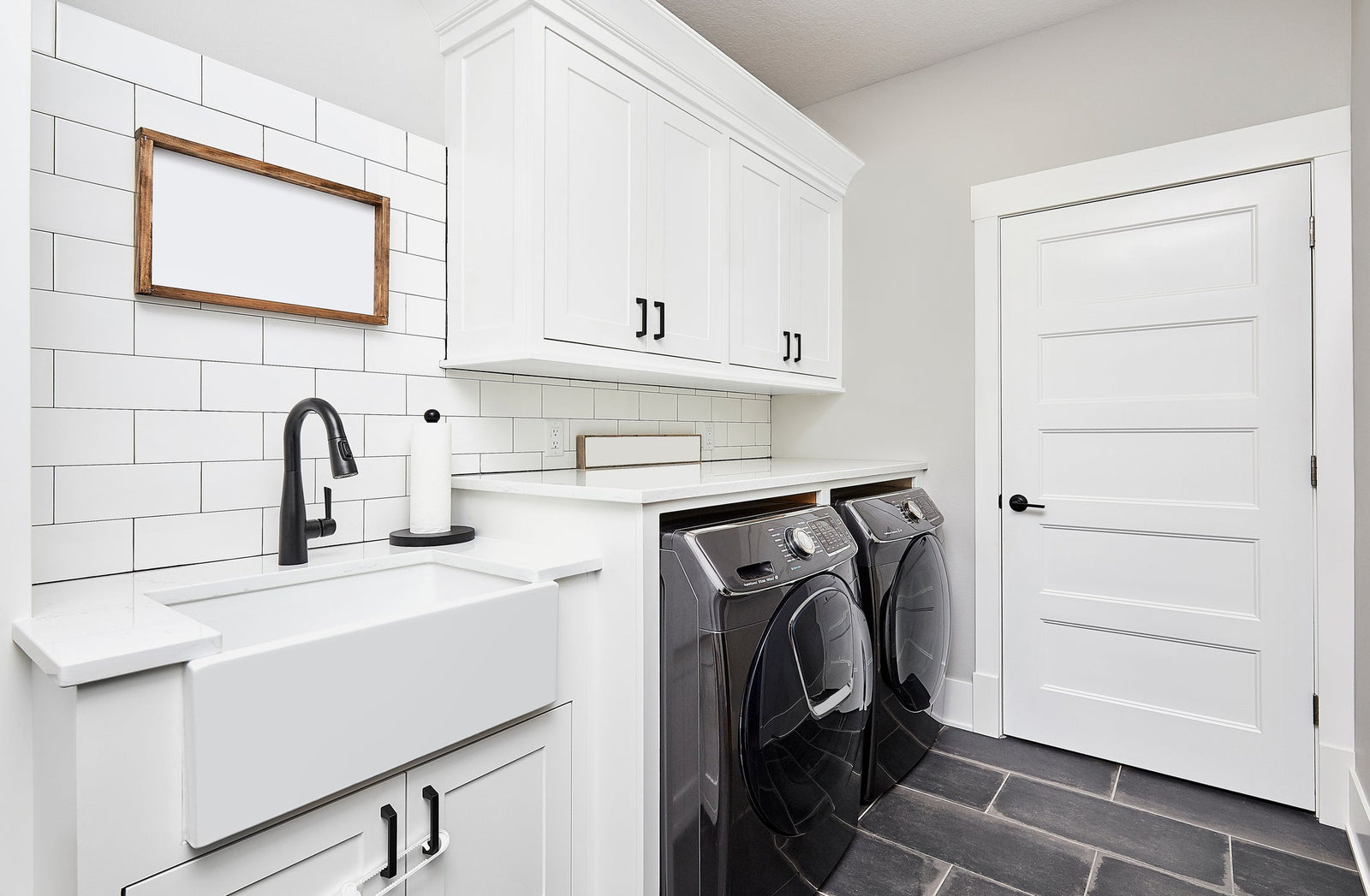 Deep laundry sink with a tall utility faucet in a bright Canadian laundry room