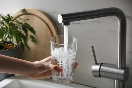 Kitchen faucet filling a glass with water
