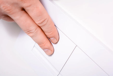 Hand pressing the button of a dual-flush toilet