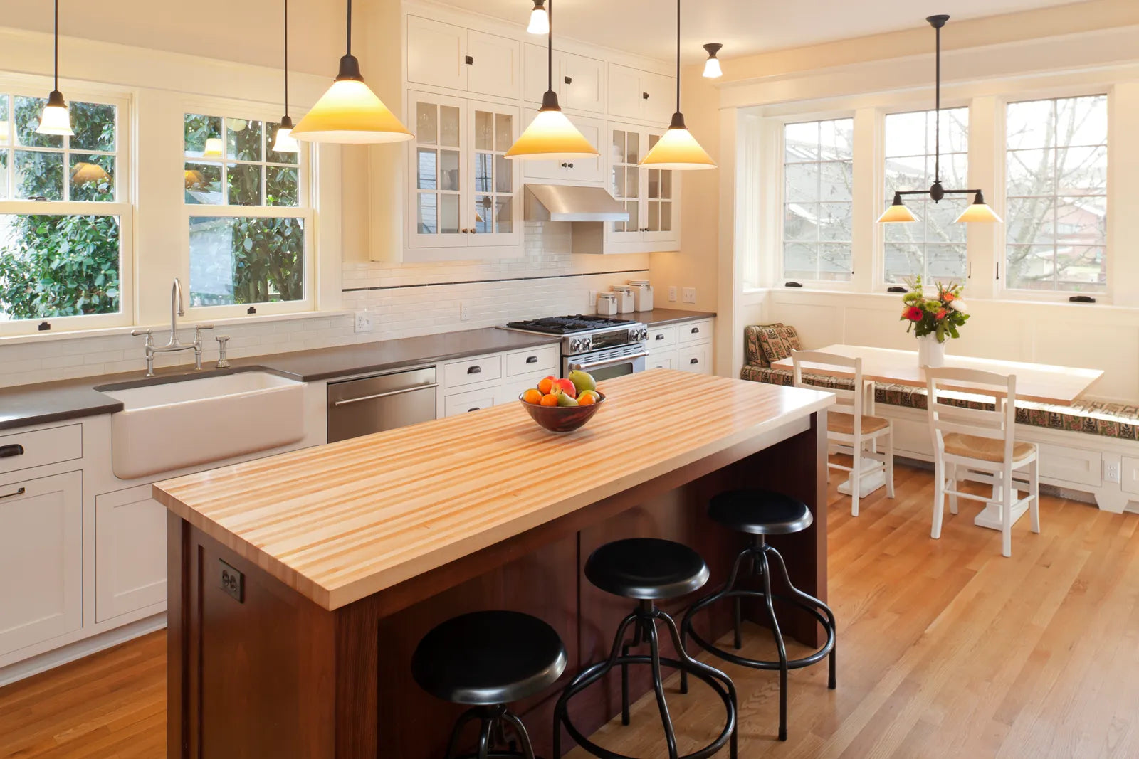 Three pendant lights hanging evenly spaced above a kitchen island
