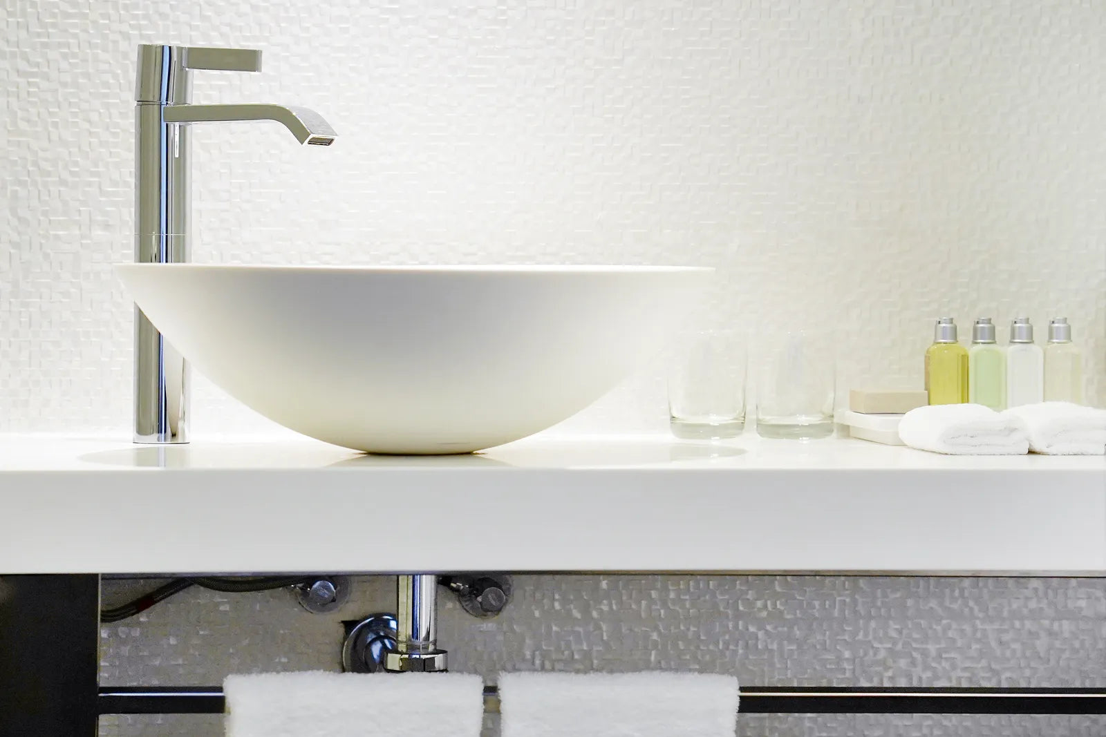 Chrome waste and overflow drain assembly installed in a white bathtub