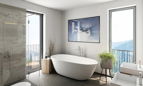 Freestanding bathtub in a modern bathroom with grey tiles