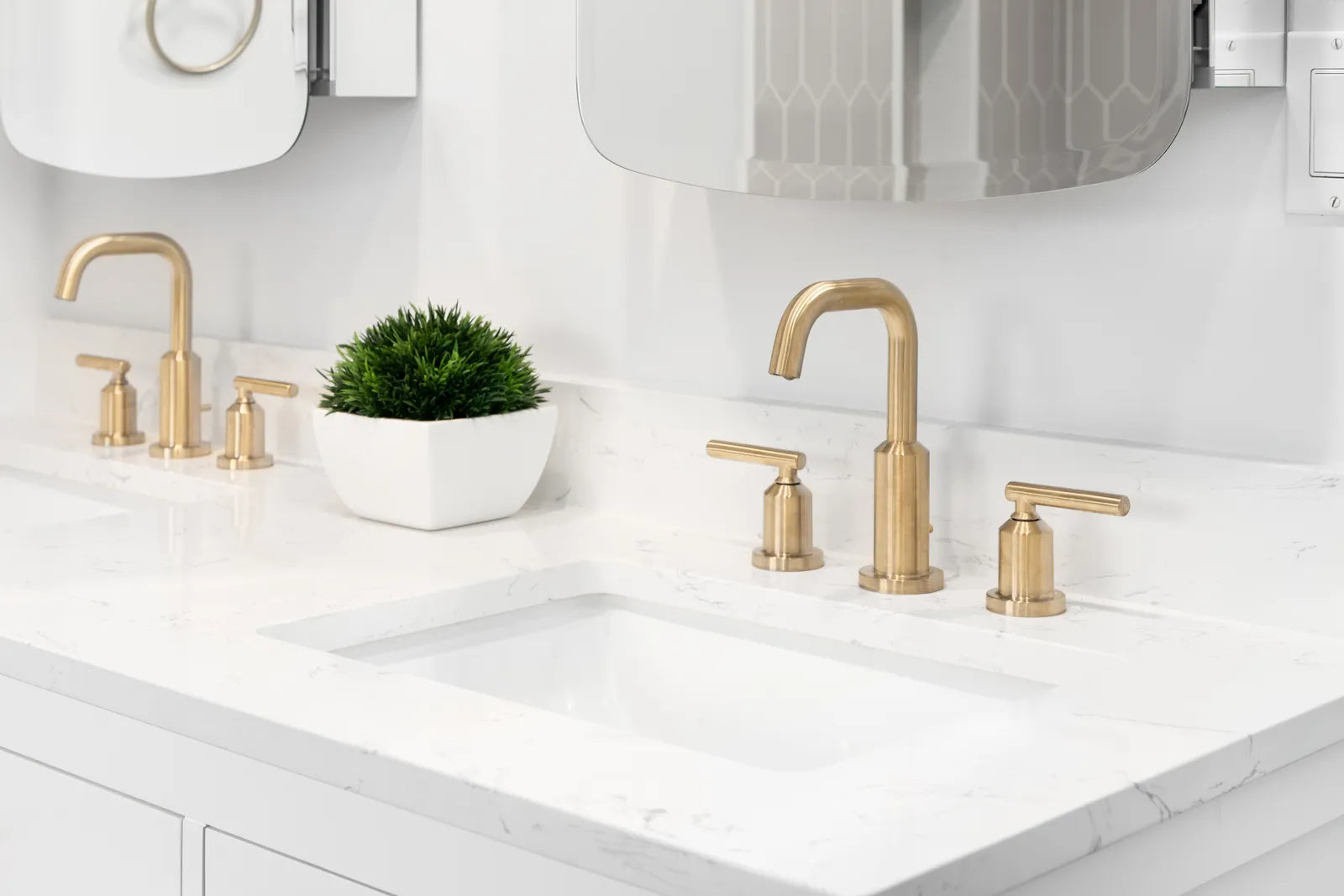 White engineered quartz vanity top with an undermount sink in a bright modern bathroom
