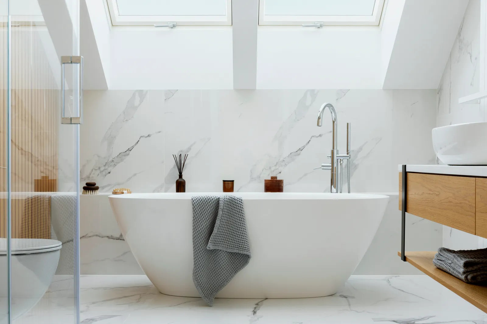 Sleek skirted two-piece toilet in a bright modern bathroom