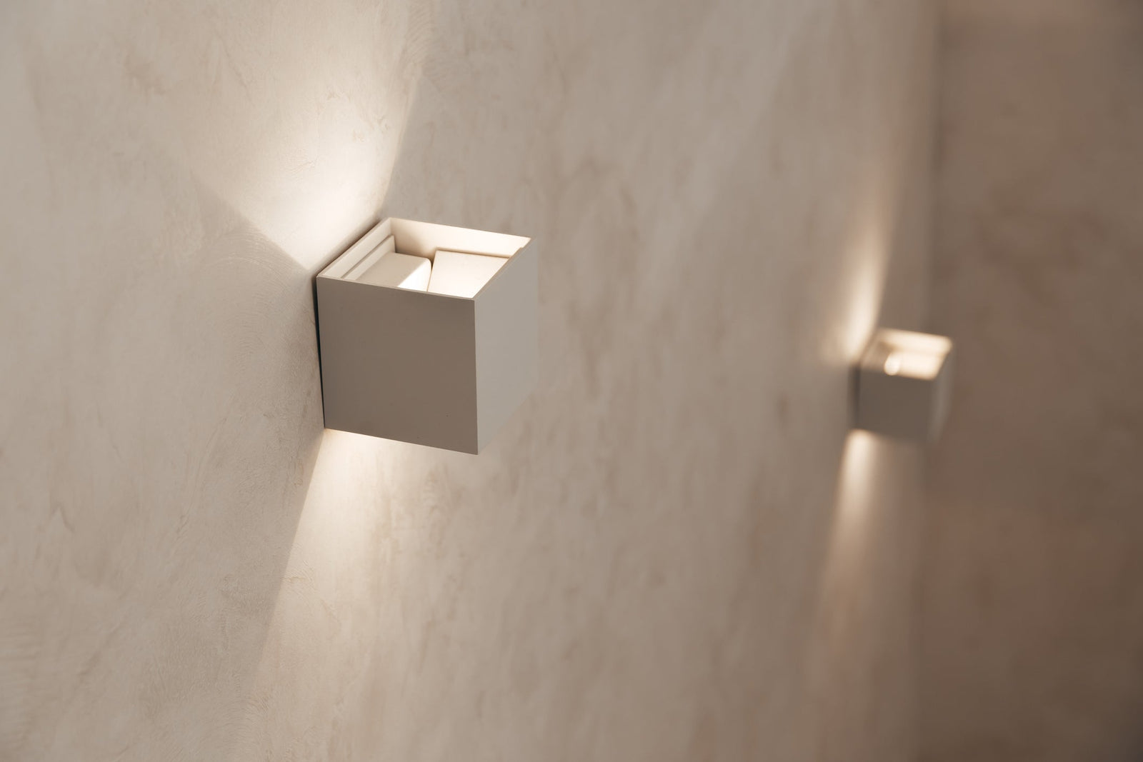 Pair of modern wall sconces flanking a bathroom vanity mirror