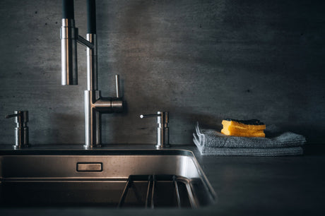 Stainless steel bottom grid resting inside a kitchen sink bowl