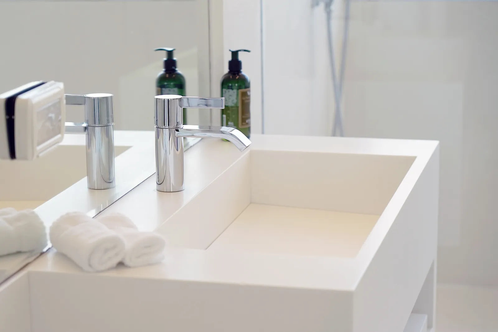Chrome push-button bathtub drain and overflow plate in a white bathtub