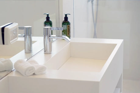 Chrome push-button bathtub drain and overflow plate in a white bathtub