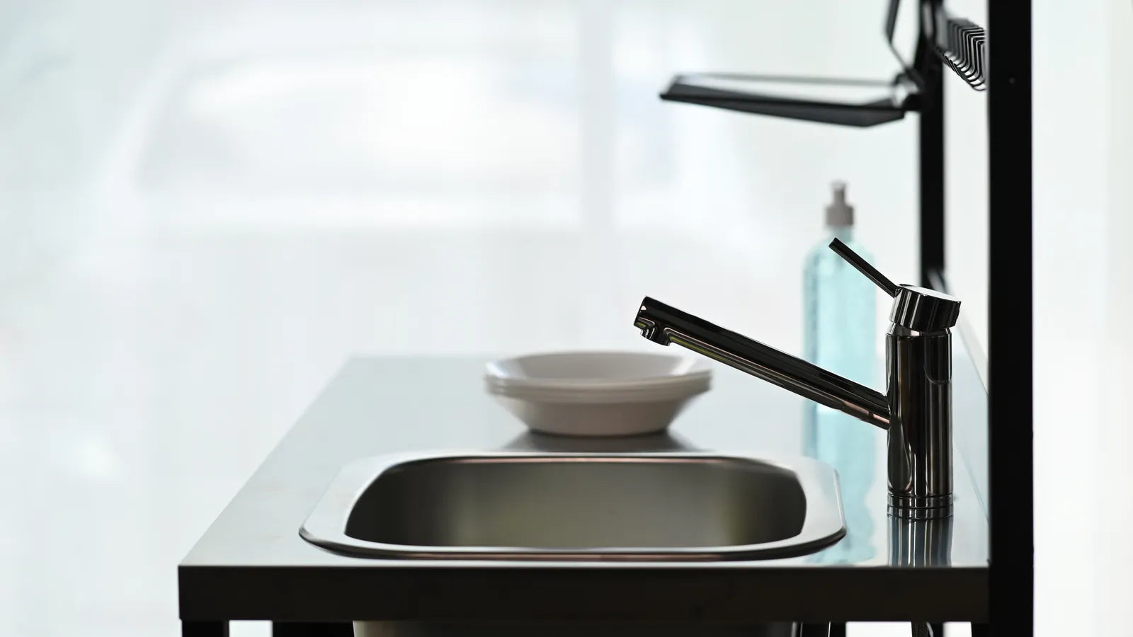 Stainless steel double bowl kitchen sink with a modern faucet in a bright kitchen