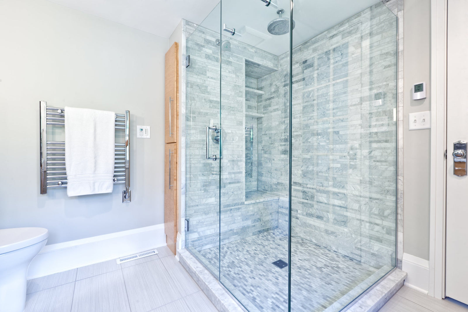 Modern bathroom with a frameless glass shower door and tiled walk-in shower
