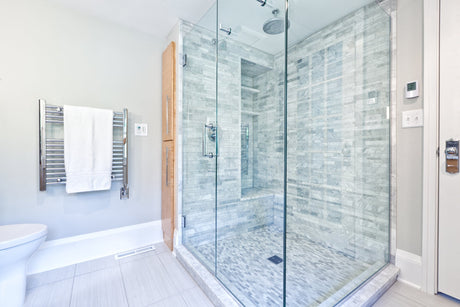 Modern bathroom with a frameless glass shower door and tiled walk-in shower