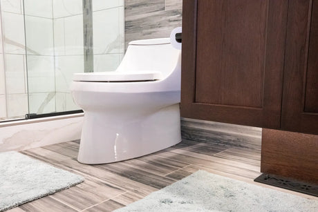 Modern bathroom featuring a skirted one-piece toilet