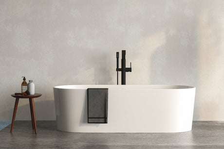 White alcove bathtub installed in a bright modern bathroom with a tile surround