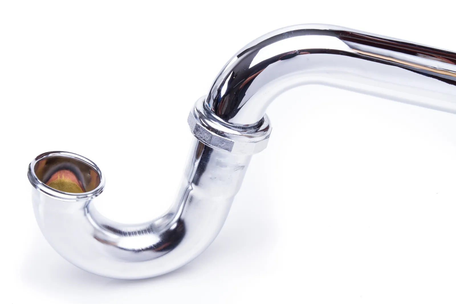 Polished chrome P-trap and drain assembly beneath a bathroom sink against a tiled wall