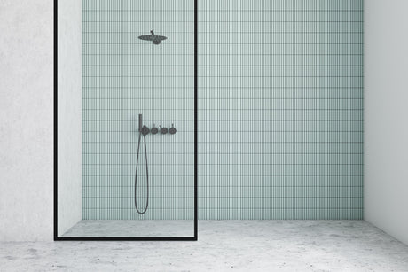 Homeowner and contractor reviewing fixture specification sheets during a bathroom renovation in Canada