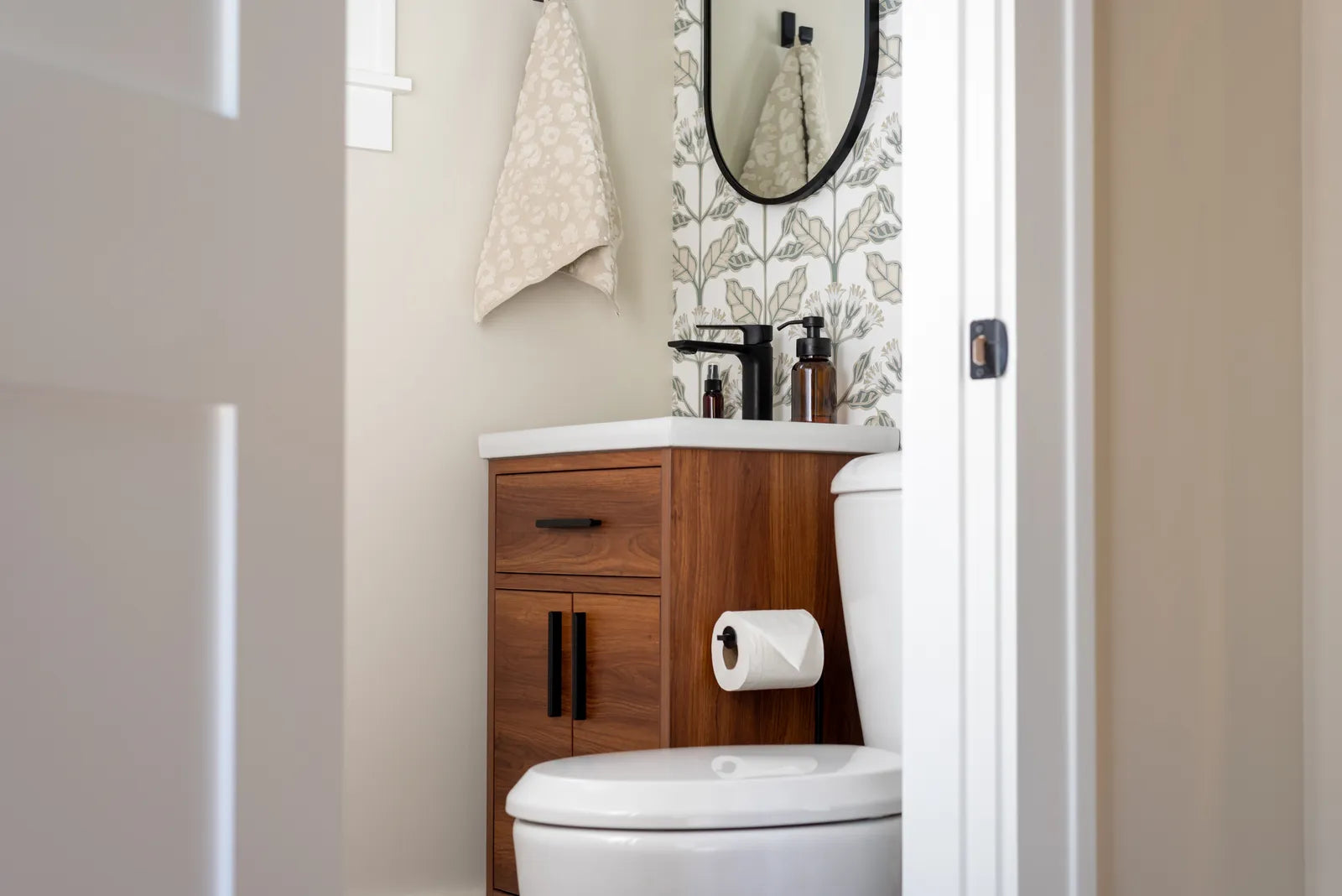 Compact wall-mounted vanity with a small basin in a bright powder room