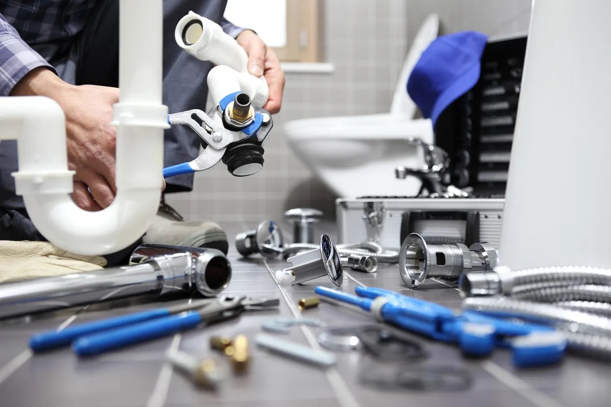Plumber working on bathroom plumbing