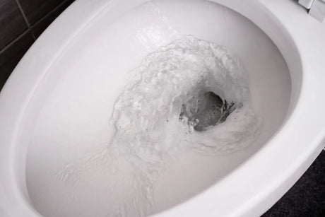 Water swirling through a toilet bowl during a flush