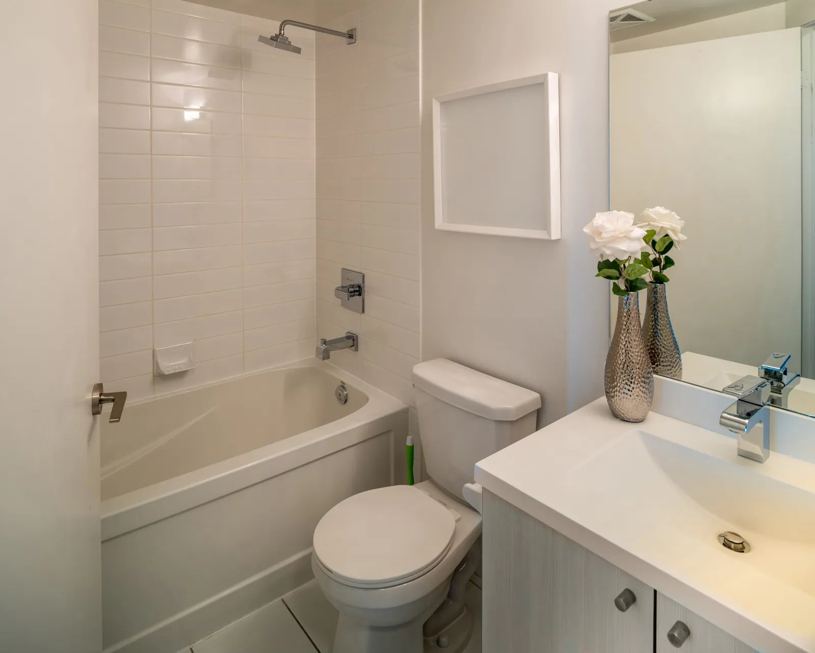 Neo-angle corner shower with glass door installed in a small bathroom