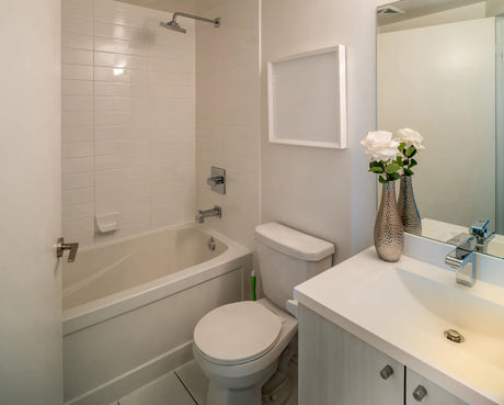 Neo-angle corner shower with glass door installed in a small bathroom