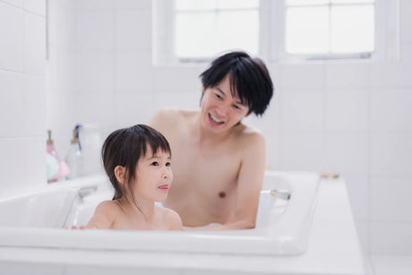 Deep freestanding Japanese soaking tub in a compact modern bathroom