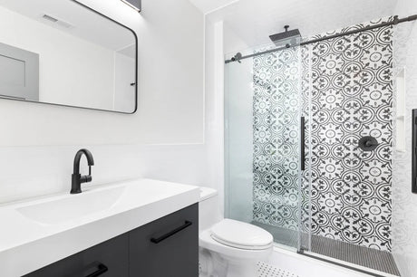 Modern bathroom with a sliding glass shower door over a tub-shower alcove