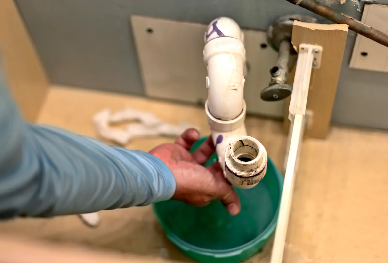 Chrome-plated P-trap and drain assembly installed under a bathroom sink