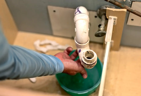 Chrome-plated P-trap and drain assembly installed under a bathroom sink