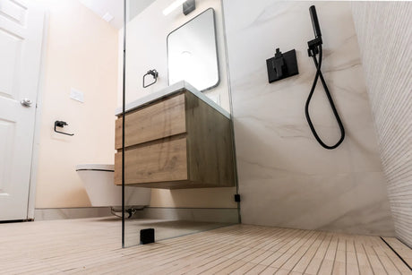Modern curbless walk-in shower with linear drain and fixed glass panel