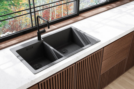 Black stainless steel workstation kitchen sink with sliding cutting board and drying rack over the bowl