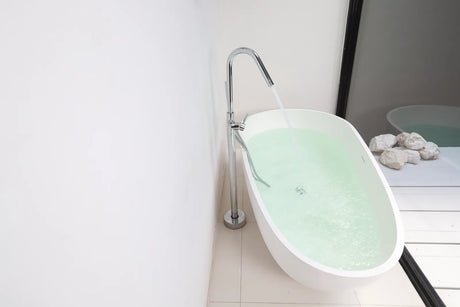 Freestanding bathtub with a floor-mounted tub filler in a modern bathroom