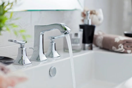 Water pouring from a modern bathroom faucet