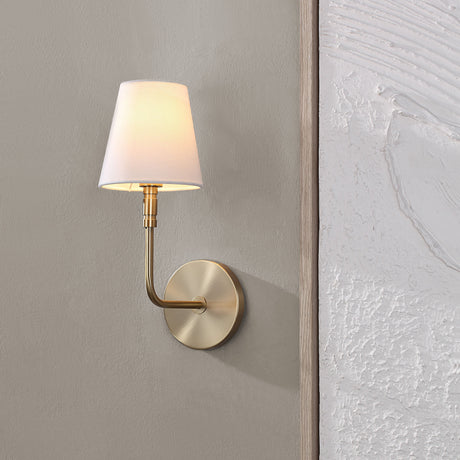 Renwil Milia 1-light wall sconce installed on a wall in a modern home, lit