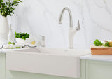 Blanco Artona Pull-Out Faucet and soap dispenser installed in a bright, transitional kitchen over a matching sink basin—Soft White finish