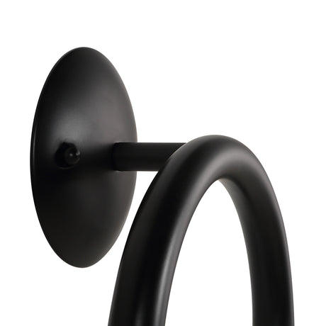 Close-up of the Santo wall sconce round backplate and curved iron arm