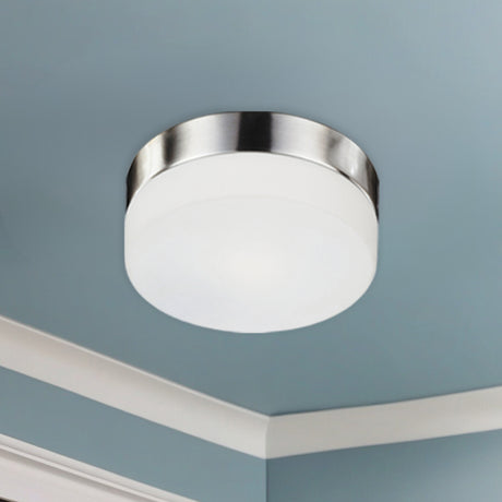 Kuzco Lomita 12-inch flush mount in Brushed Nickel installed on a ceiling with crown moulding