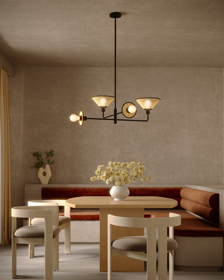Alora Mood Piper chandelier in Matte Black lit over a dining table