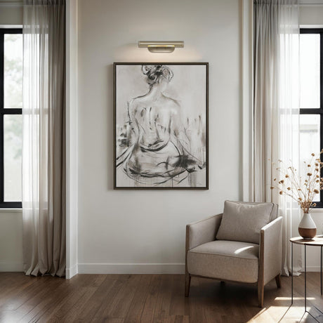 Renwil Opale library wall sconce installed above framed artwork in a living room