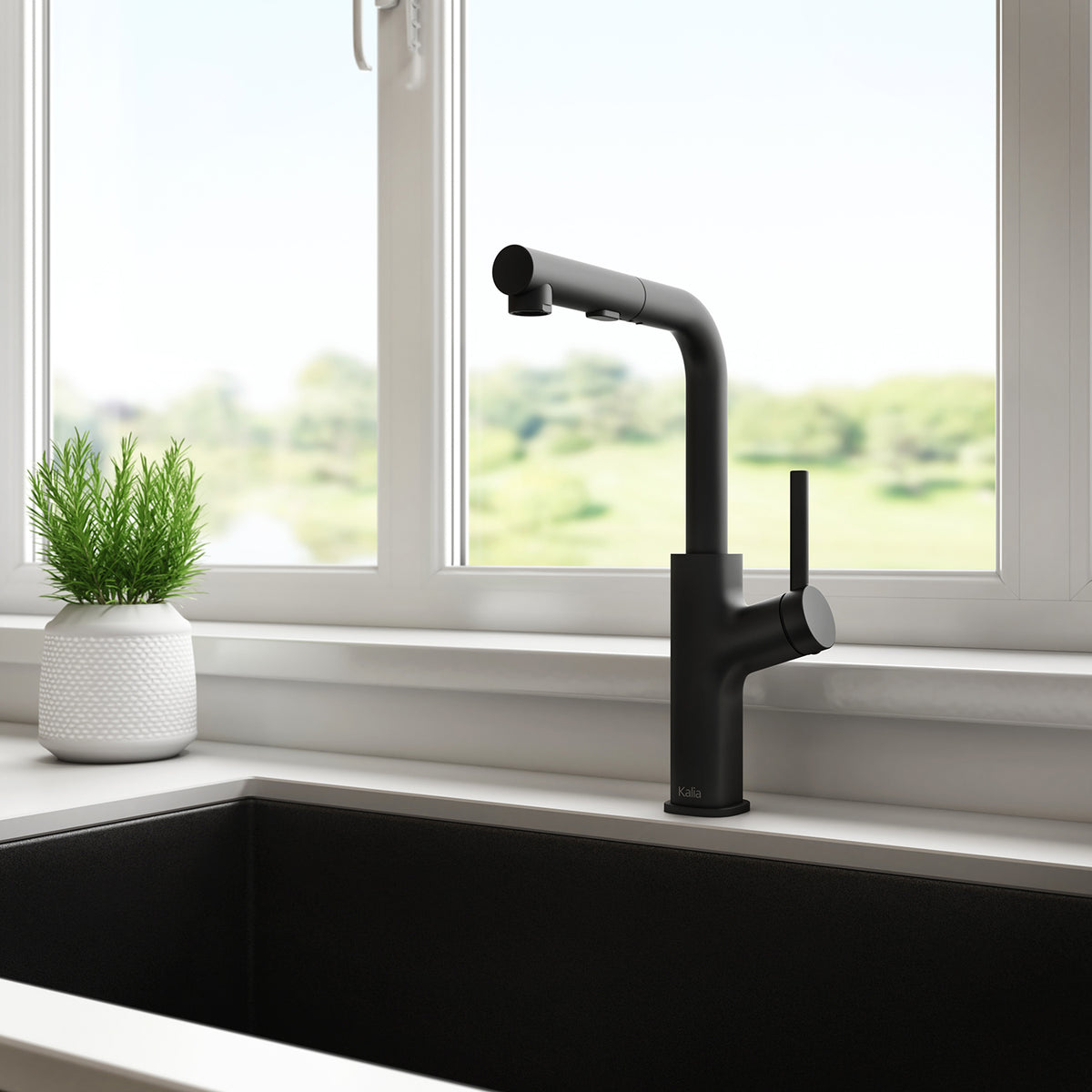 Kalia Masimo Surfer pull-out kitchen faucet in Matte Black mounted at a kitchen sink by a window