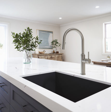 Kalia Enora Diver kitchen faucet with high-arc spout in a bright kitchen setting