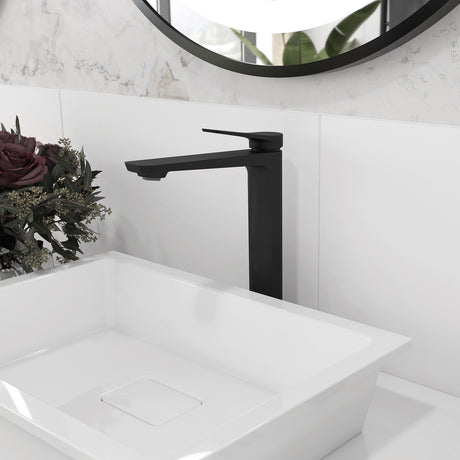 Kalia Moroka tall single hole bathroom sink faucet in Matte Black installed above a vessel sink, angled view